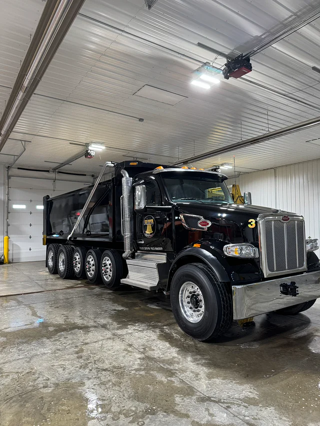 Black dump truck with polished chrome after detailing