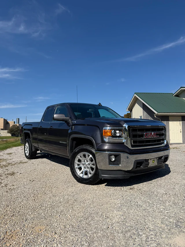Glossy black GMC pickup after detailing